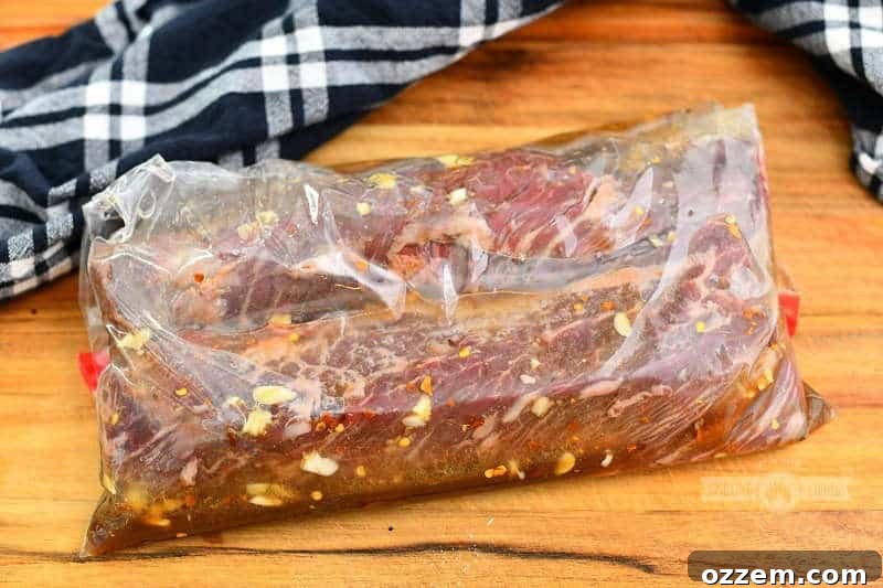 Fire Kissed Hanger Steak 4 Two hanger steaks marinating in a plastic bag with a flavorful steak marinade