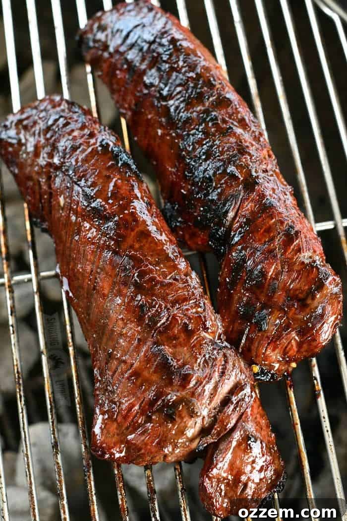 Fire Kissed Hanger Steak 5 Two perfectly cooked hanger steaks resting on grill grates