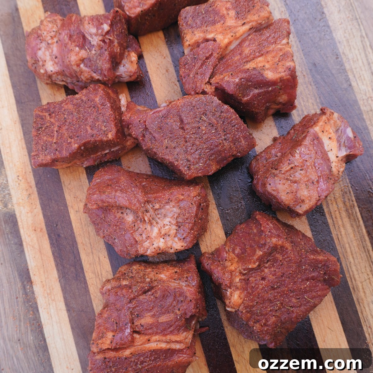 Raw chuck roast cut into squares, ready for seasoning