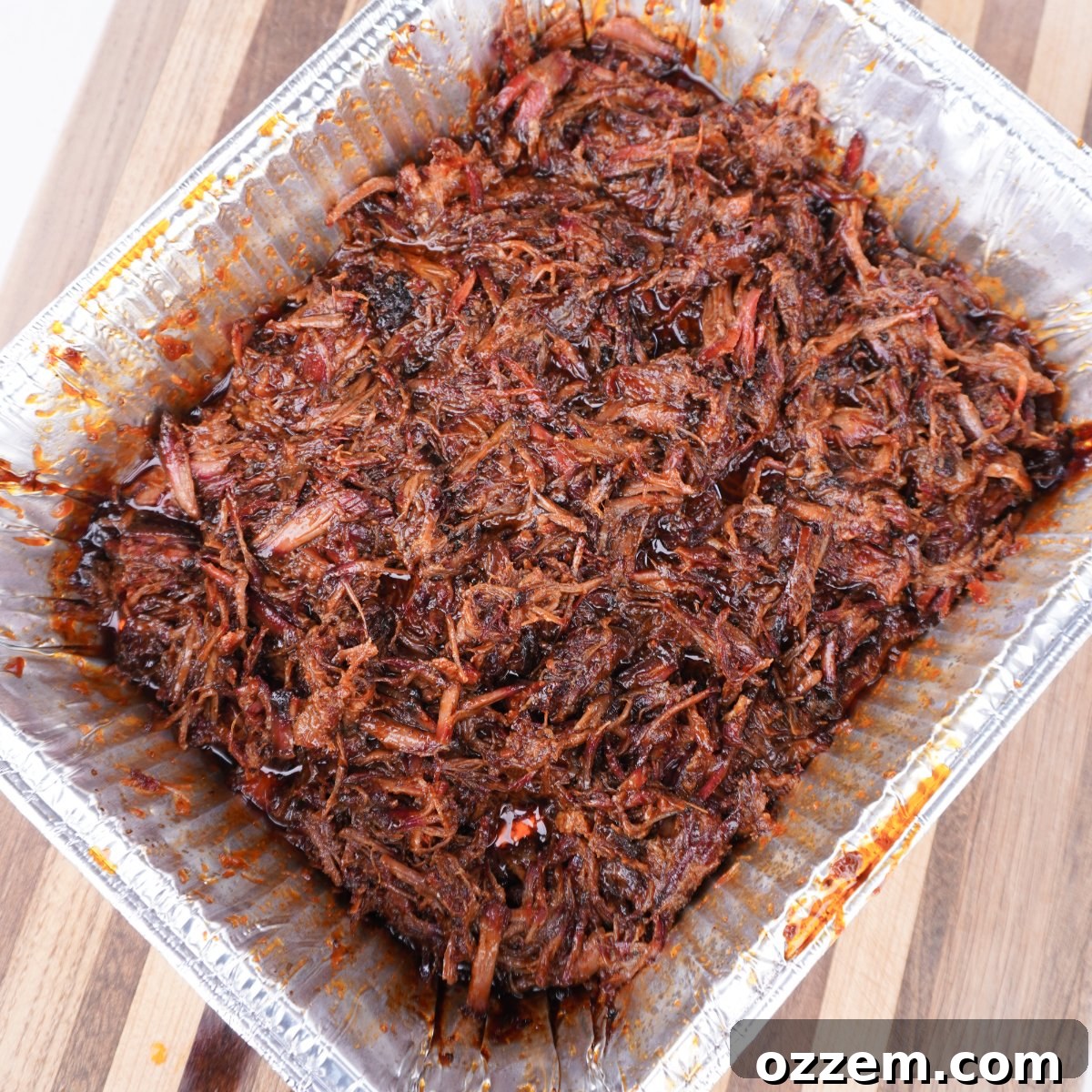 Close-up of a fully assembled shredded beef sandwich on a French roll