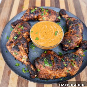 Grilled Peri Peri Chicken with a side of sauce.