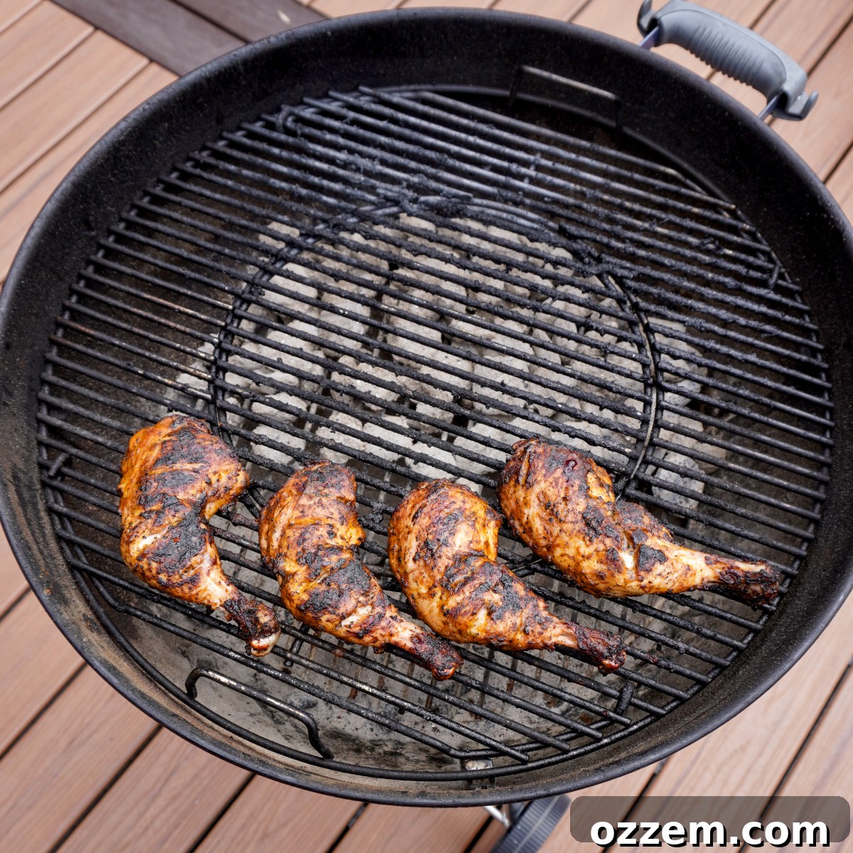 Peri Peri Chicken grilling over charcoal, showing a beautiful sear.