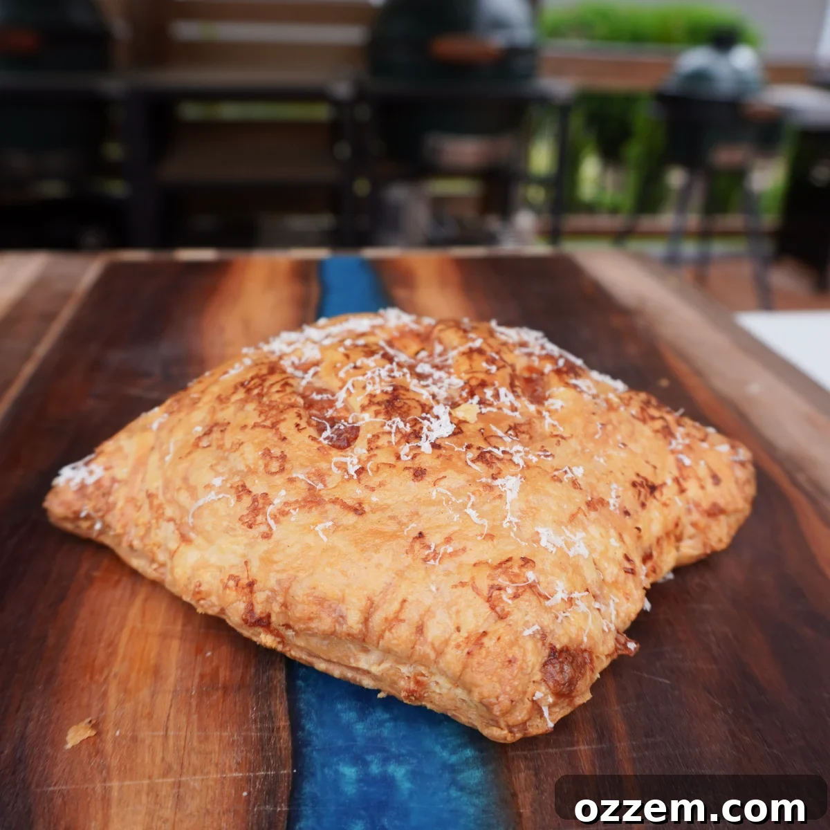 Savory Puff Pastry Parcels 2 Crispy golden brown puff pastry meat pockets on a baking sheet.