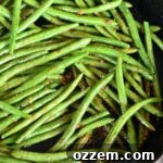 top view of cooked green beans in a skillet on the grill