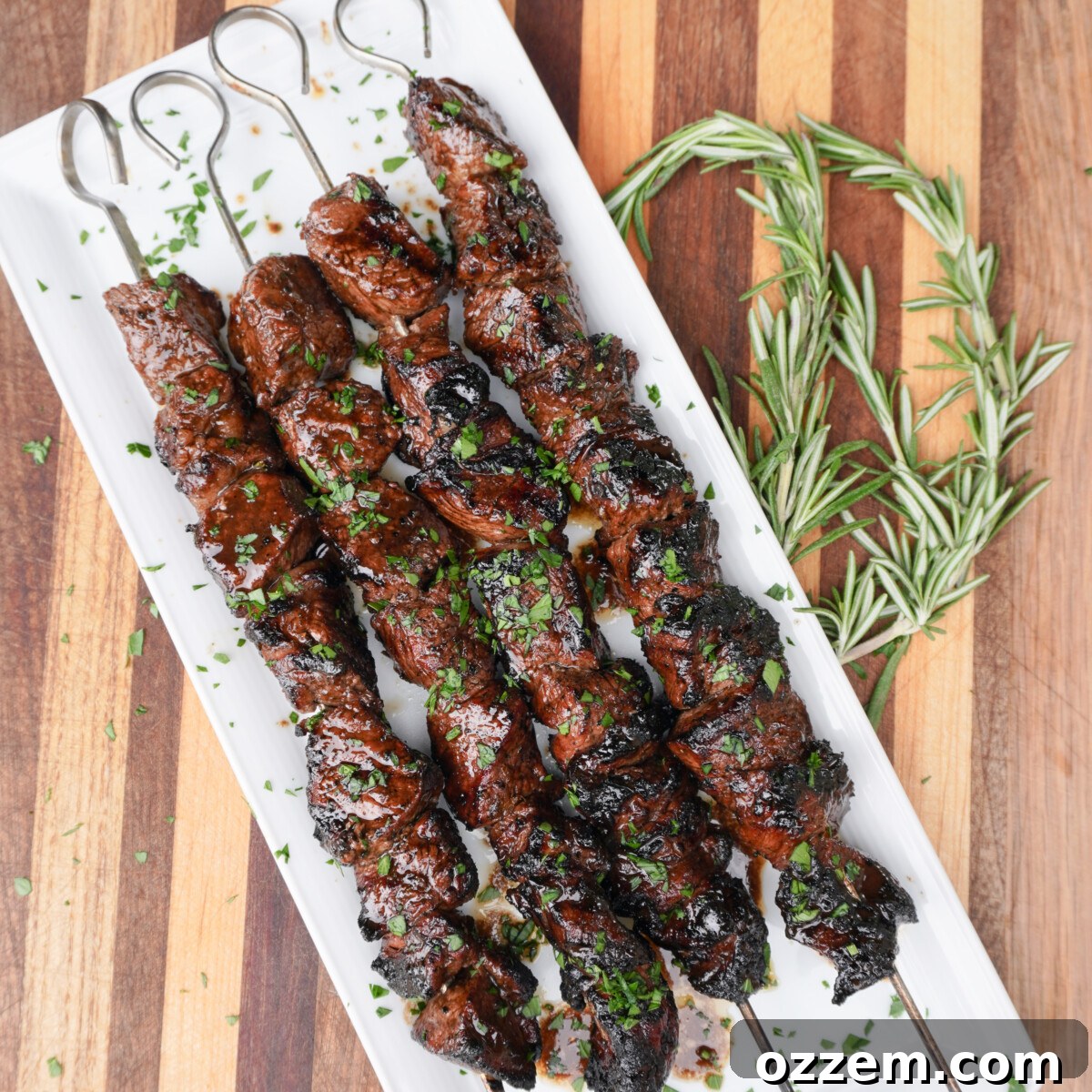 Zesty Balsamic Lamb Skewers 2 Grilled Balsamic Citrus Lamb Skewers on a plate, garnished.