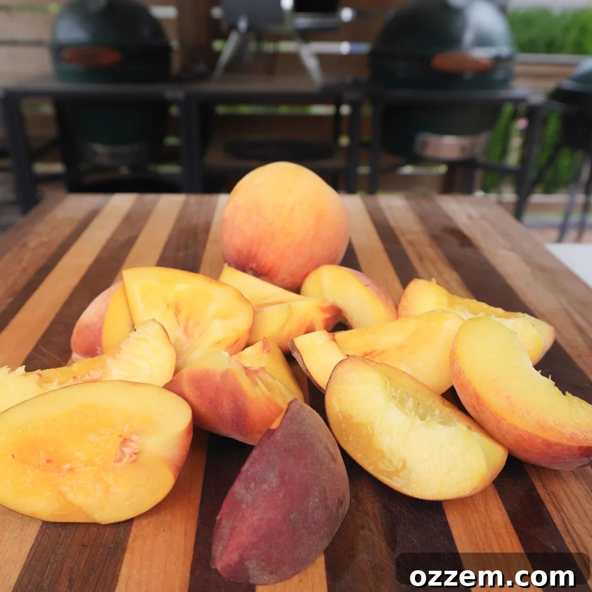 Fresh peaches cut into quarters and seasoned, ready for grilling.