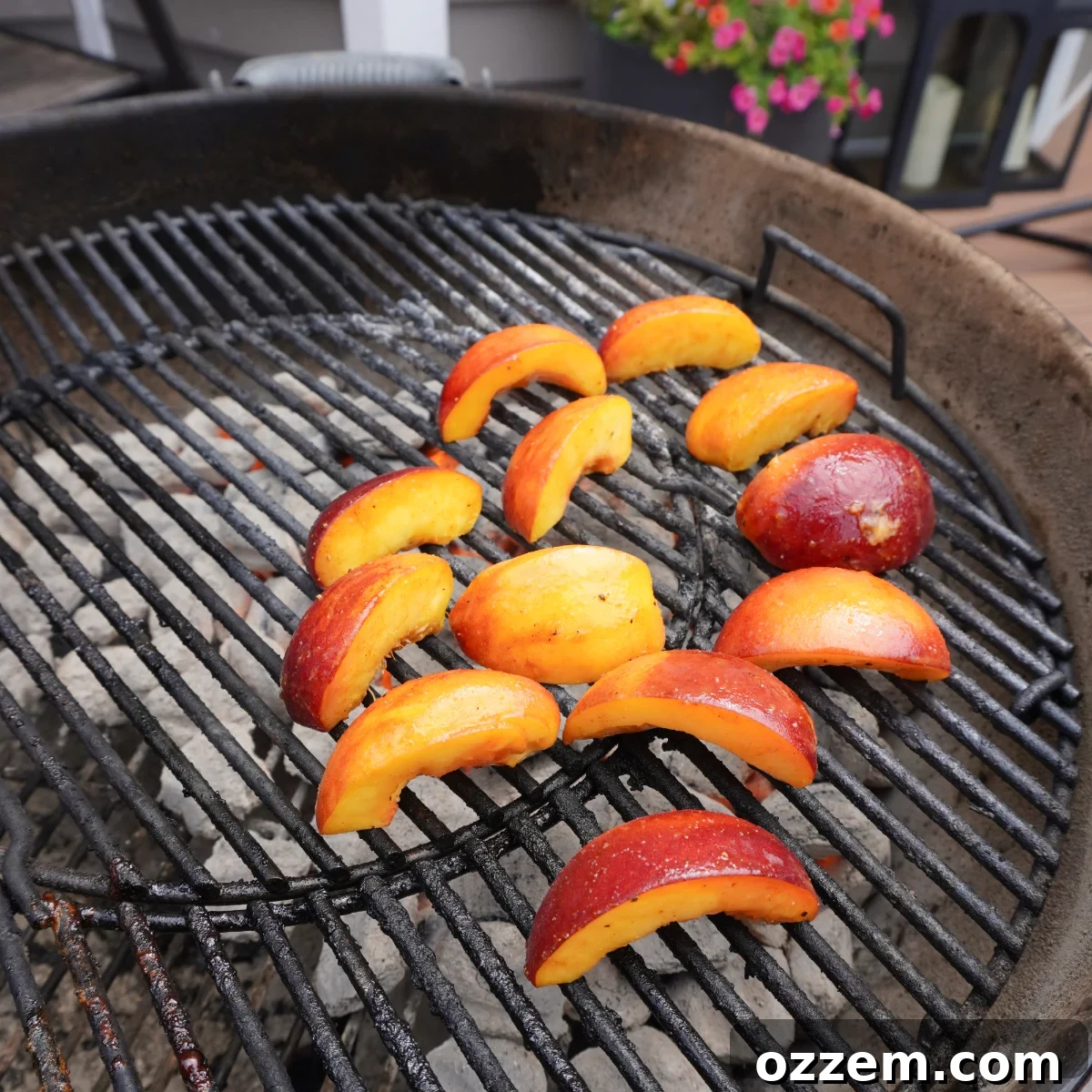 Grilled pork chops and charred peach halves arranged on a serving platter.