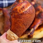 holding a smoked turkey leg
