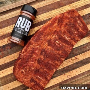 Seasoned St. Louis style spare ribs resting, allowing the BBQ rub to penetrate the meat before smoking