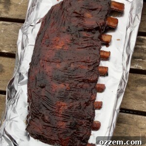 Barbecue sauce slathered ribs, glistening and ready for the final set
