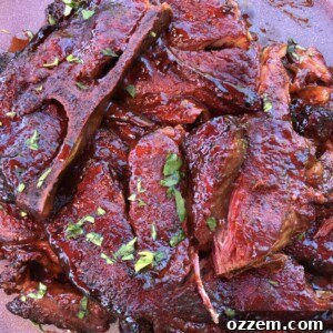 close up of slow smoked pork steaks covered in sauce