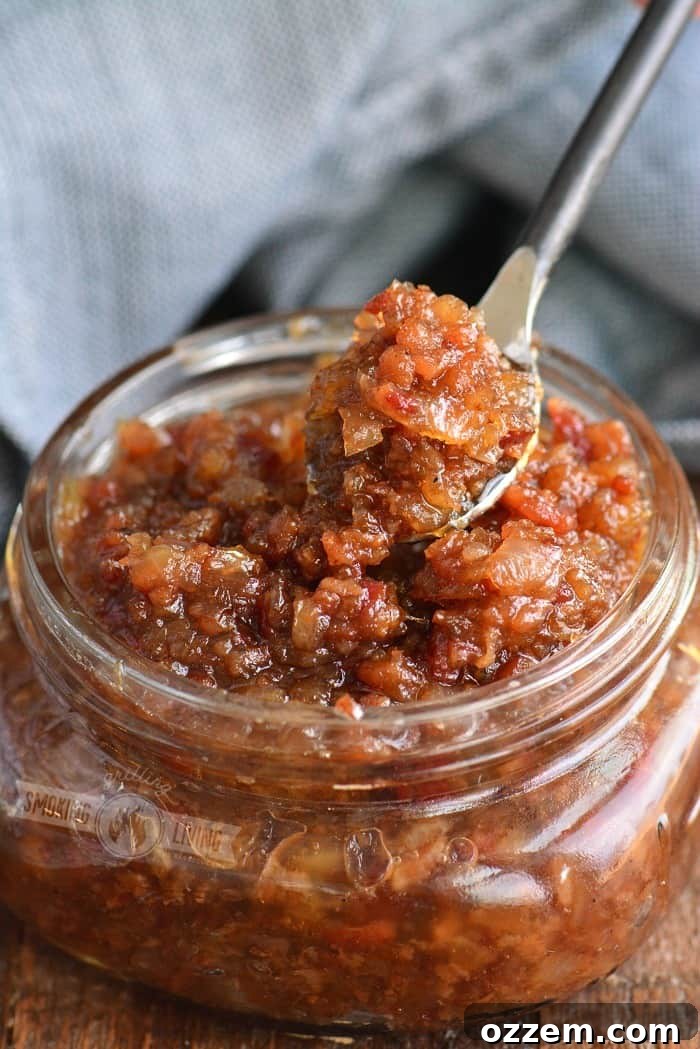 Spoon scooping out delicious homemade bacon jam from a jar