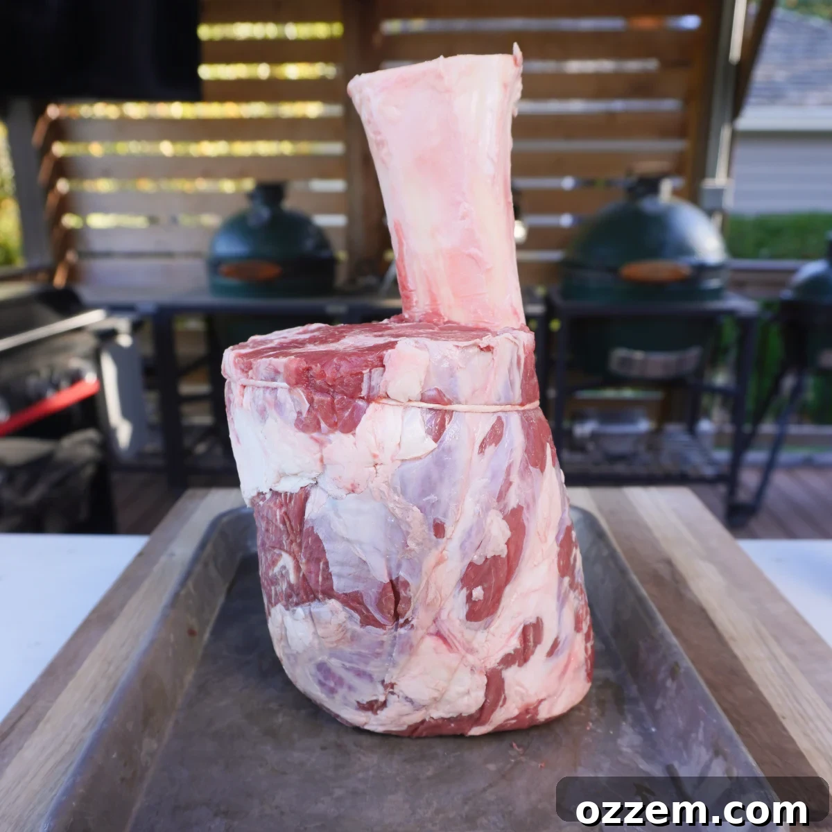Beef shank coated with yellow mustard as a binder, ready for seasoning.