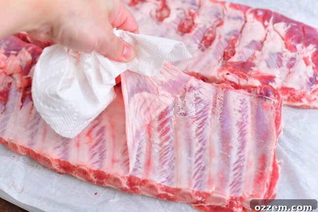 pulling off the membrane from the back of St. Louis ribs