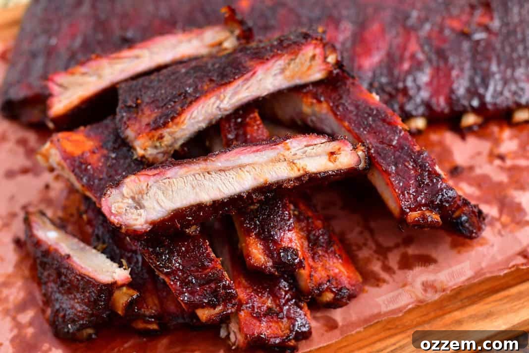 Smoked ribs cut into individual pieces, ready to be served, showcasing the tender meat and caramelized bark.