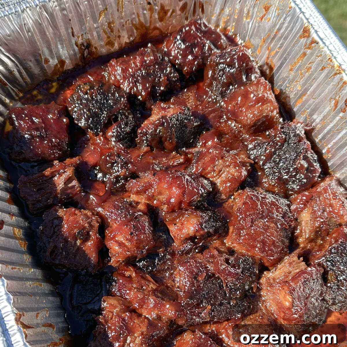 Perfectly sauced and caramelized brisket burnt ends, glistening and stacked, ready to serve