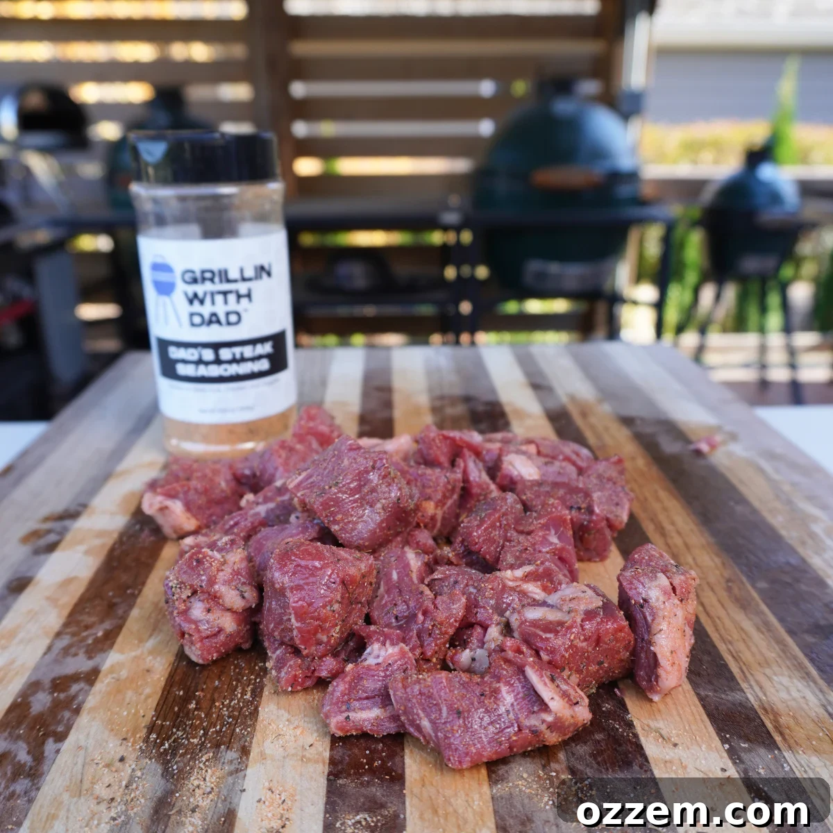 Close-up of cubed beef tenderloin tips generously seasoned with Dad's steak seasoning, ready for searing.