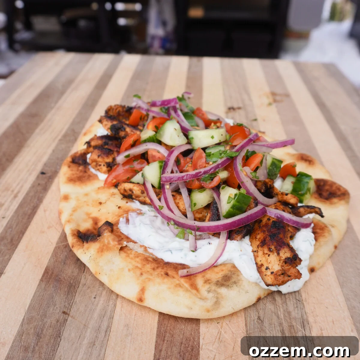 Flame Kissed Chicken Shawarma 2 Grilled Chicken Shawarma on a pita, garnished with fresh herbs and sauce.