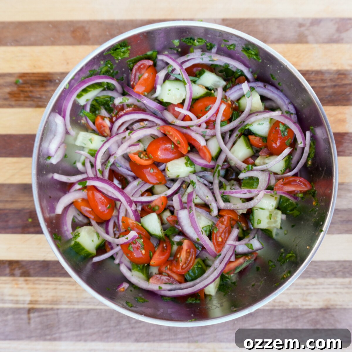 Flame Kissed Chicken Shawarma 7 Freshly chopped tomatoes, cucumber, and red onion in a blue serving bowl.