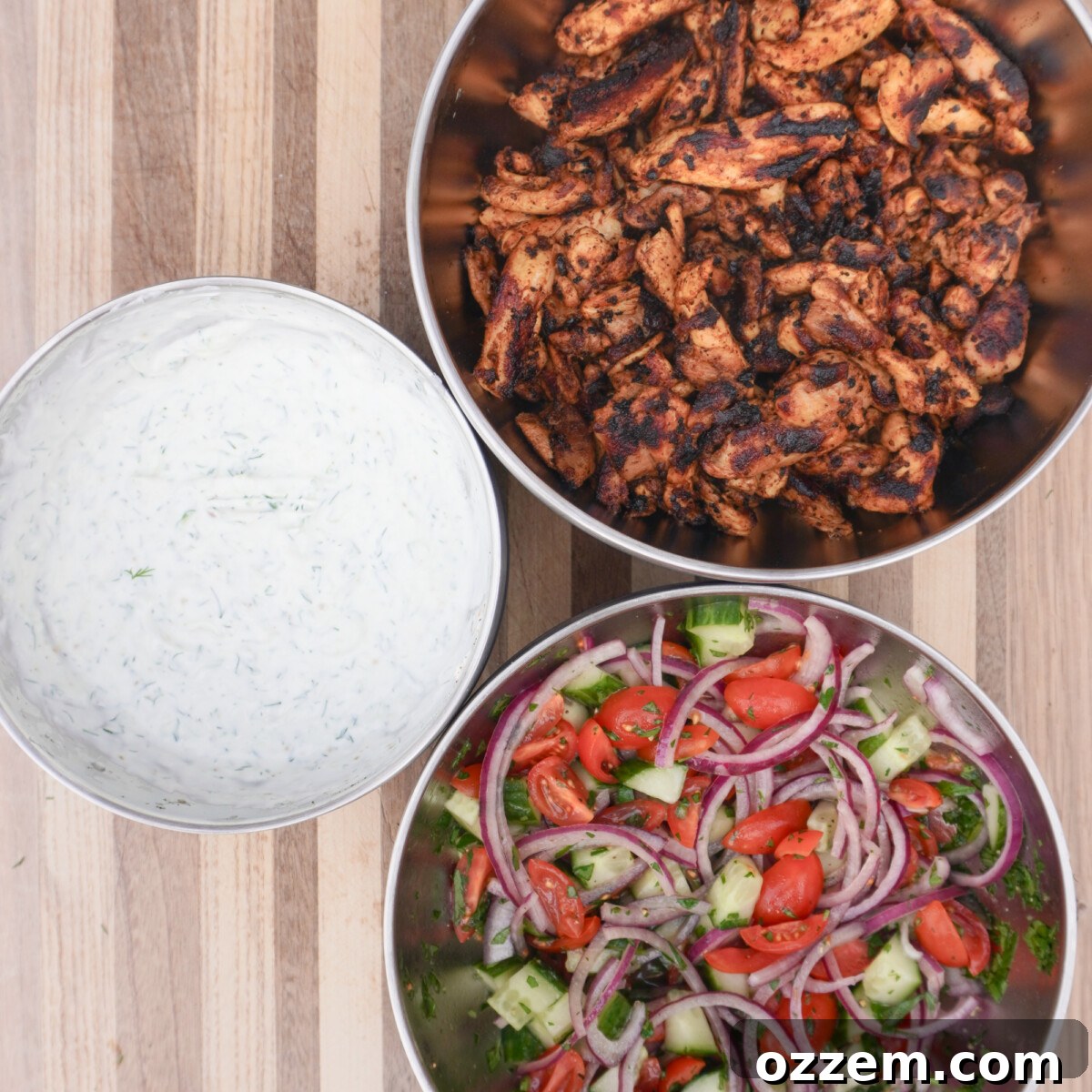 Flame Kissed Chicken Shawarma 9 Individual components of grilled chicken shawarma meal: chicken, tzatziki, and salad, ready for assembly.