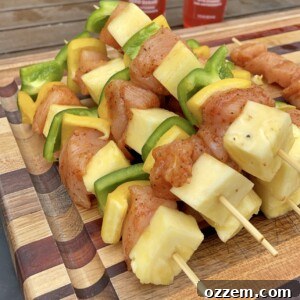 Close-up of vibrant chicken, pineapple, and bell pepper skewers prepped and ready to hit the grill.