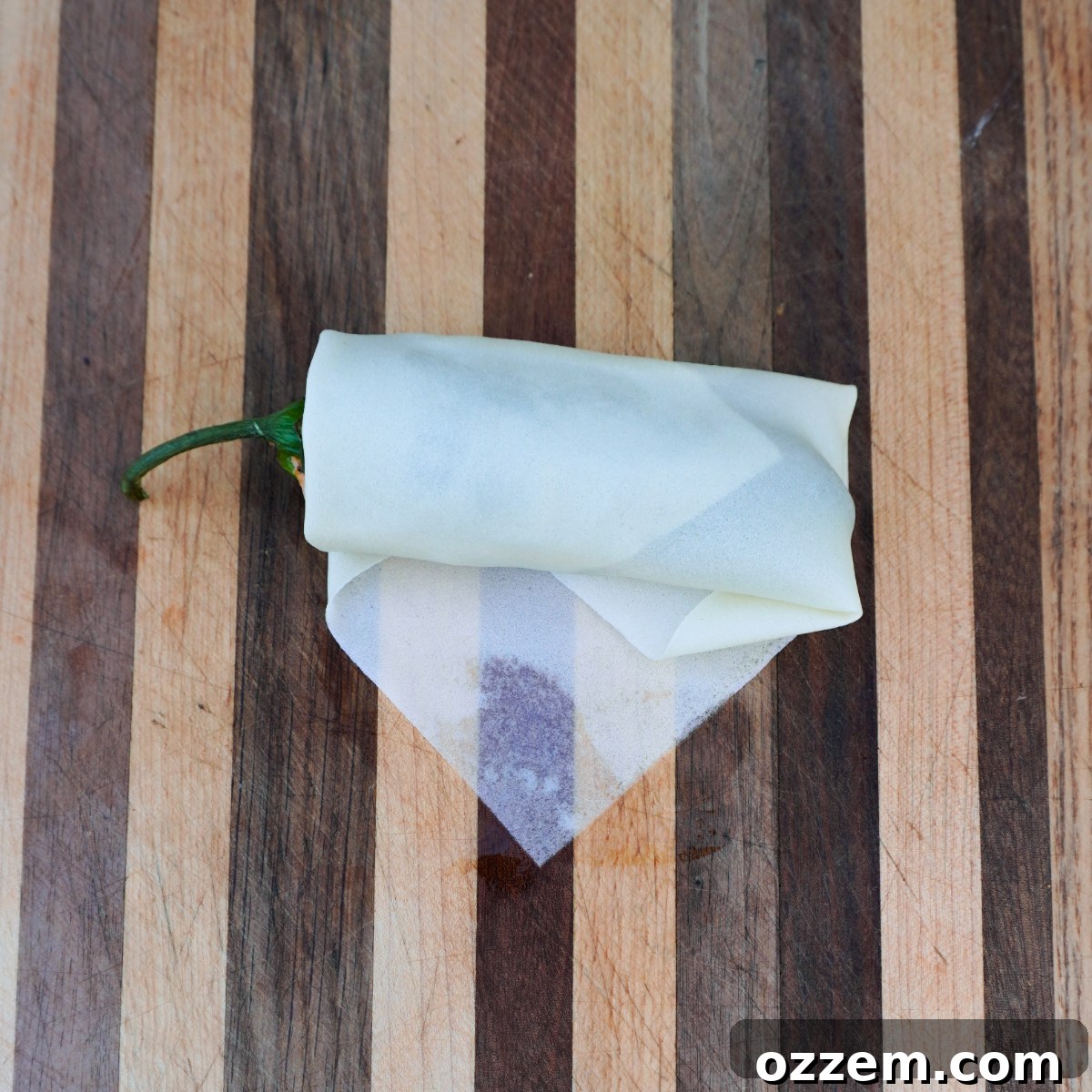 Crispy Jalapeno Popper Lumpia 11 Step-by-step image of folding a lumpia wrapper, showing the final roll.