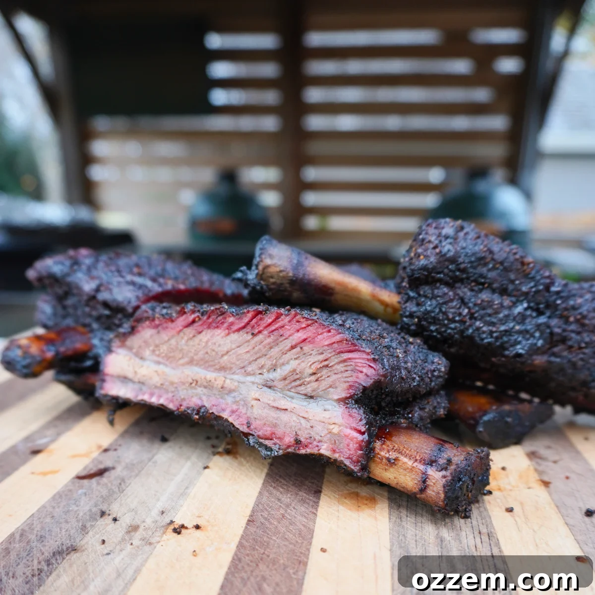 Succulent Smoked Beef Short Ribs 2 Exquisitely smoked beef short ribs, sliced and ready to serve, showcasing their tender texture and rich bark.
