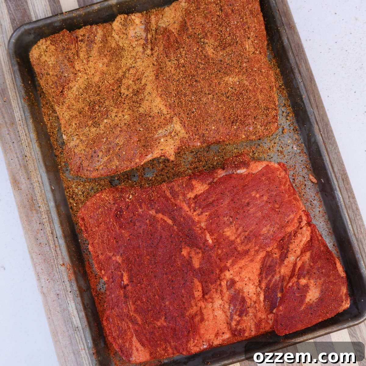 Succulent Smoked Beef Short Ribs 4 Two racks of prepared beef short ribs, generously seasoned with different BBQ rubs, ready for smoking.