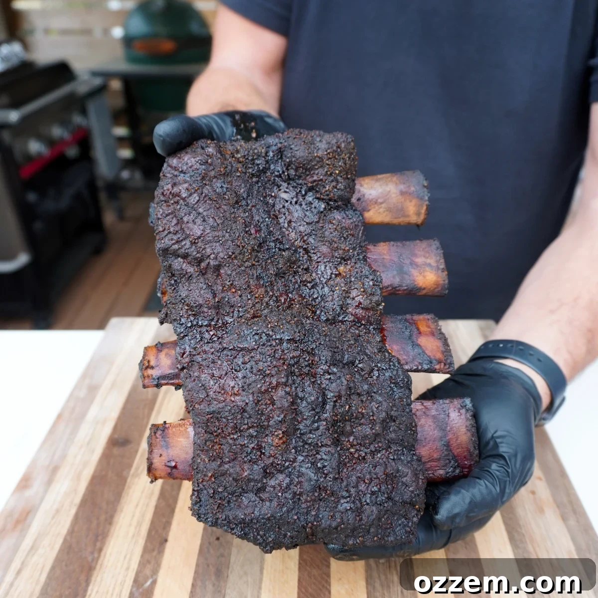 Succulent Smoked Beef Short Ribs 8 Final plated smoked beef short ribs, beautifully sliced between the bones, garnished and ready to eat.