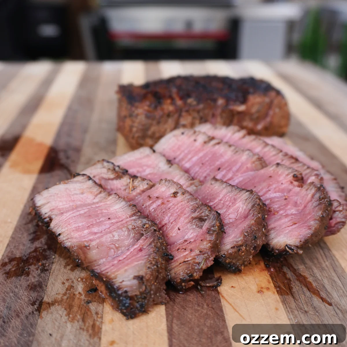 grilled and sliced steak on cutting board. 