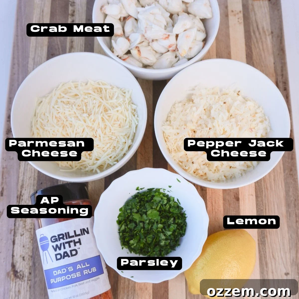 Assortment of fresh ingredients for creamy crab stuffing, including crab meat, cheese, mayo, and lemon.