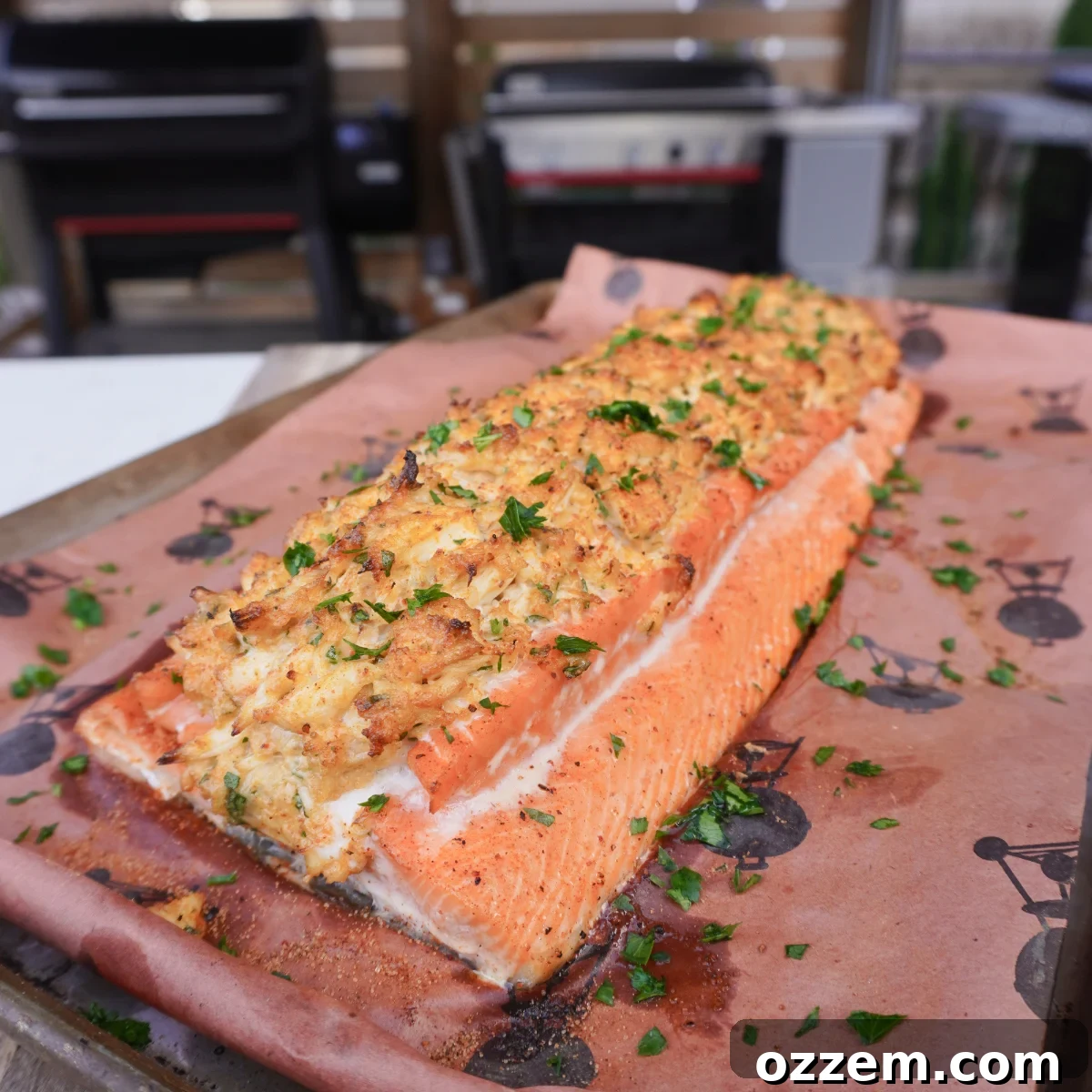 Smoked crab stuffed salmon on butcher paper and cutting board, ready to be served.