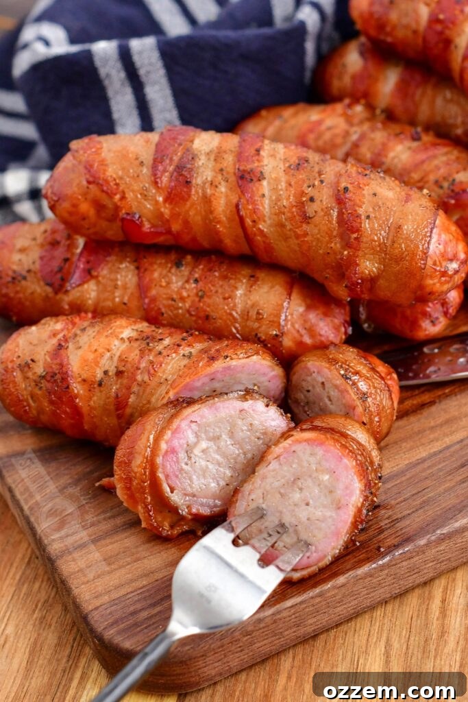 Sliced smoked bacon-wrapped sausage revealing juicy interior, with a fork ready for a bite