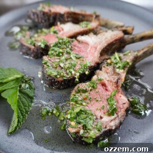 A perfectly cooked rack of lamb with mint chimichurri sauce.