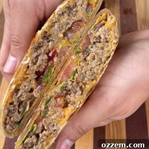 The finished, golden-brown Chopped Cheese Crunchwrap, sliced and ready to eat.