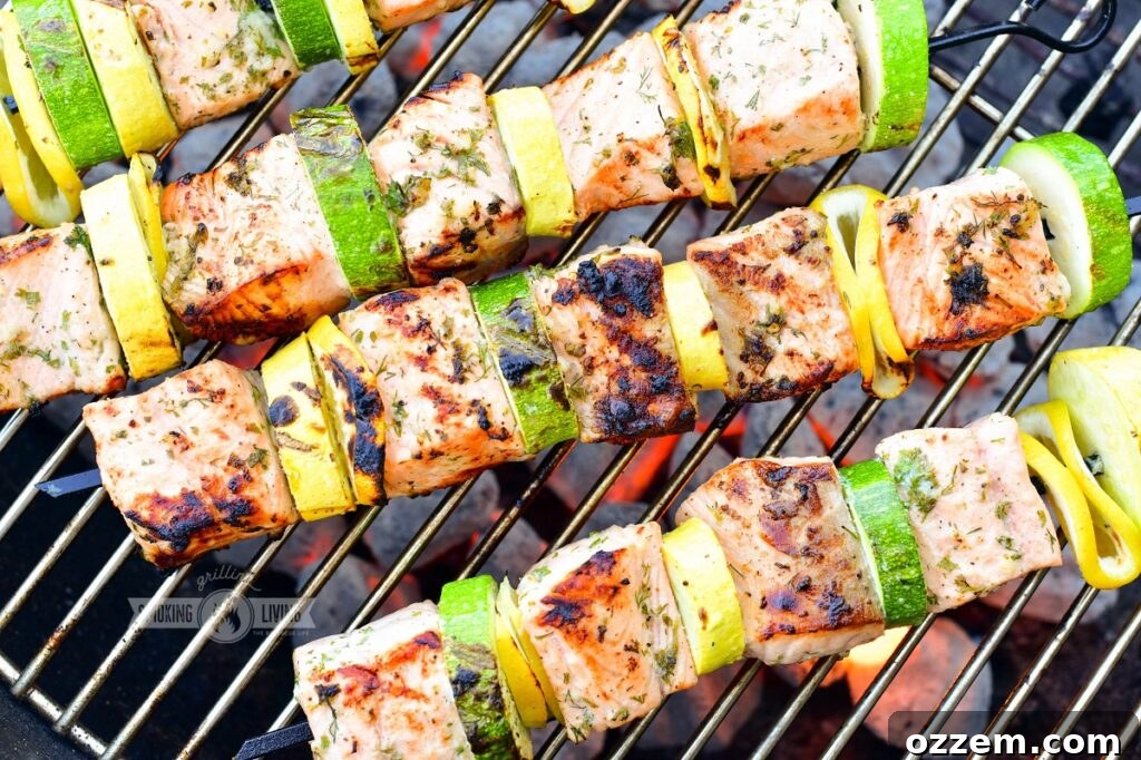 Multiple grilled salmon kebabs on a grill grate