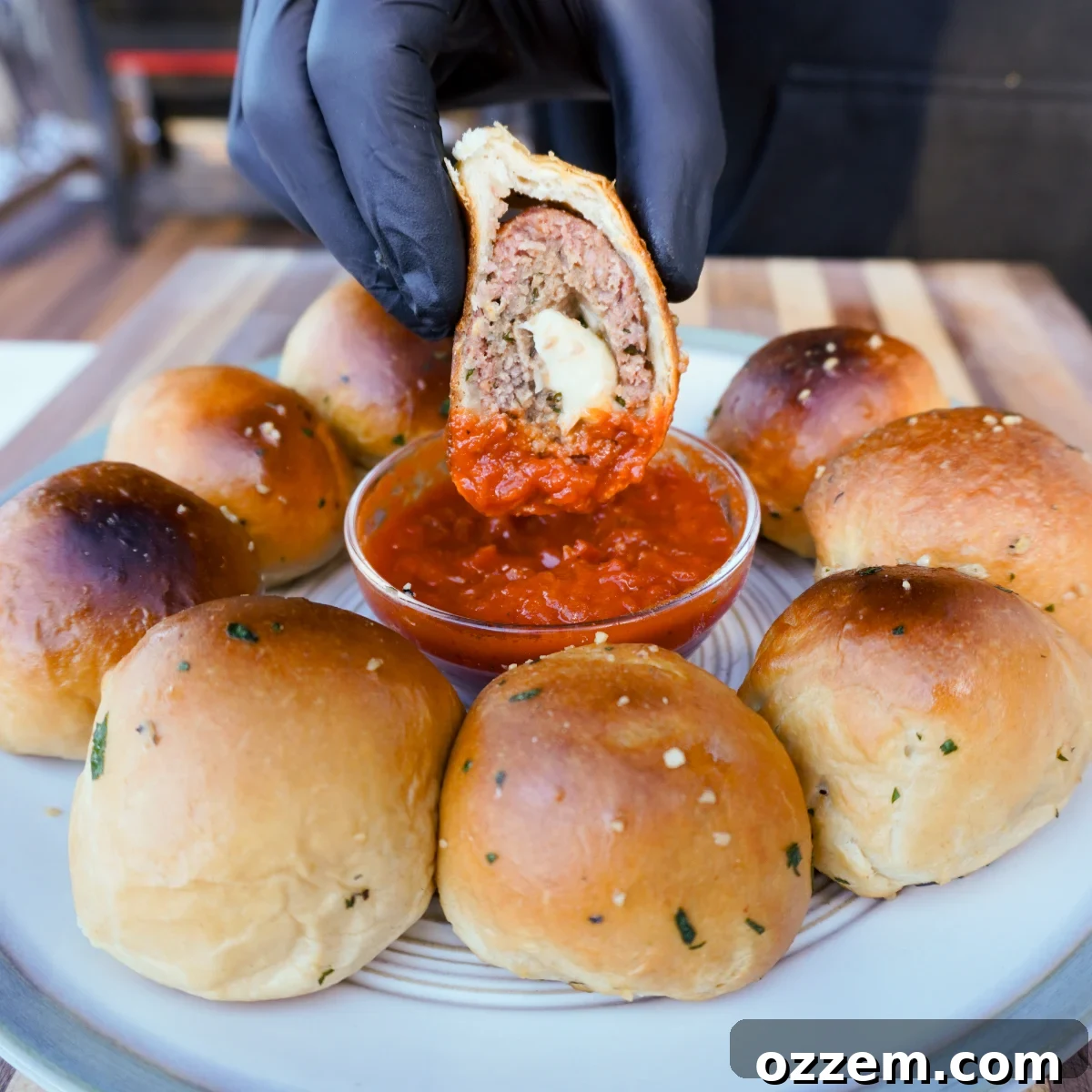 sliced smoked meatball biscuits dipped in marinara sauce.