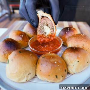 sliced smoked meatball biscuits dipped in marinara sauce.
