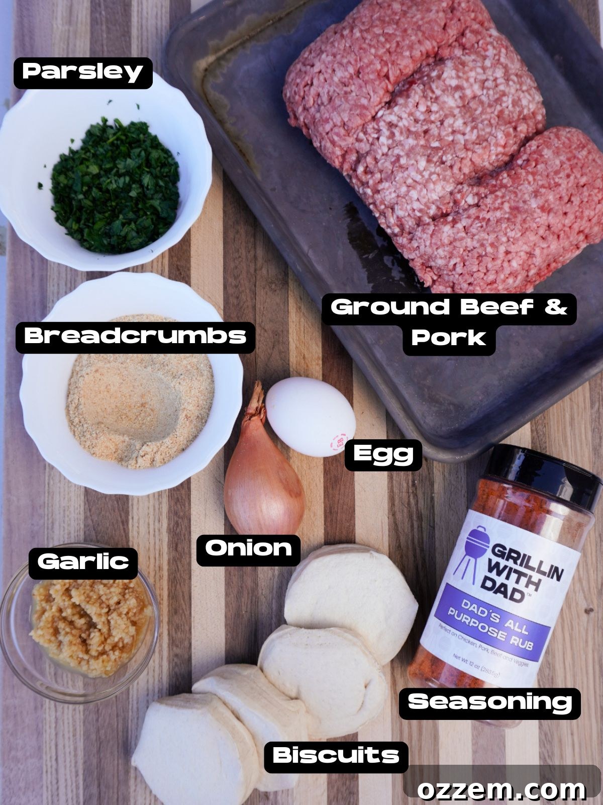 Various ingredients for smoked meatball biscuits laid out on a table.
