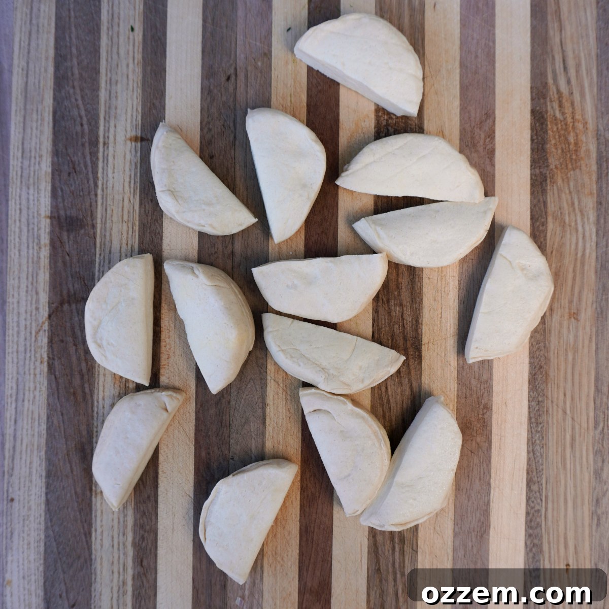 Sliced in half biscuit dough rounds, ready for filling.
