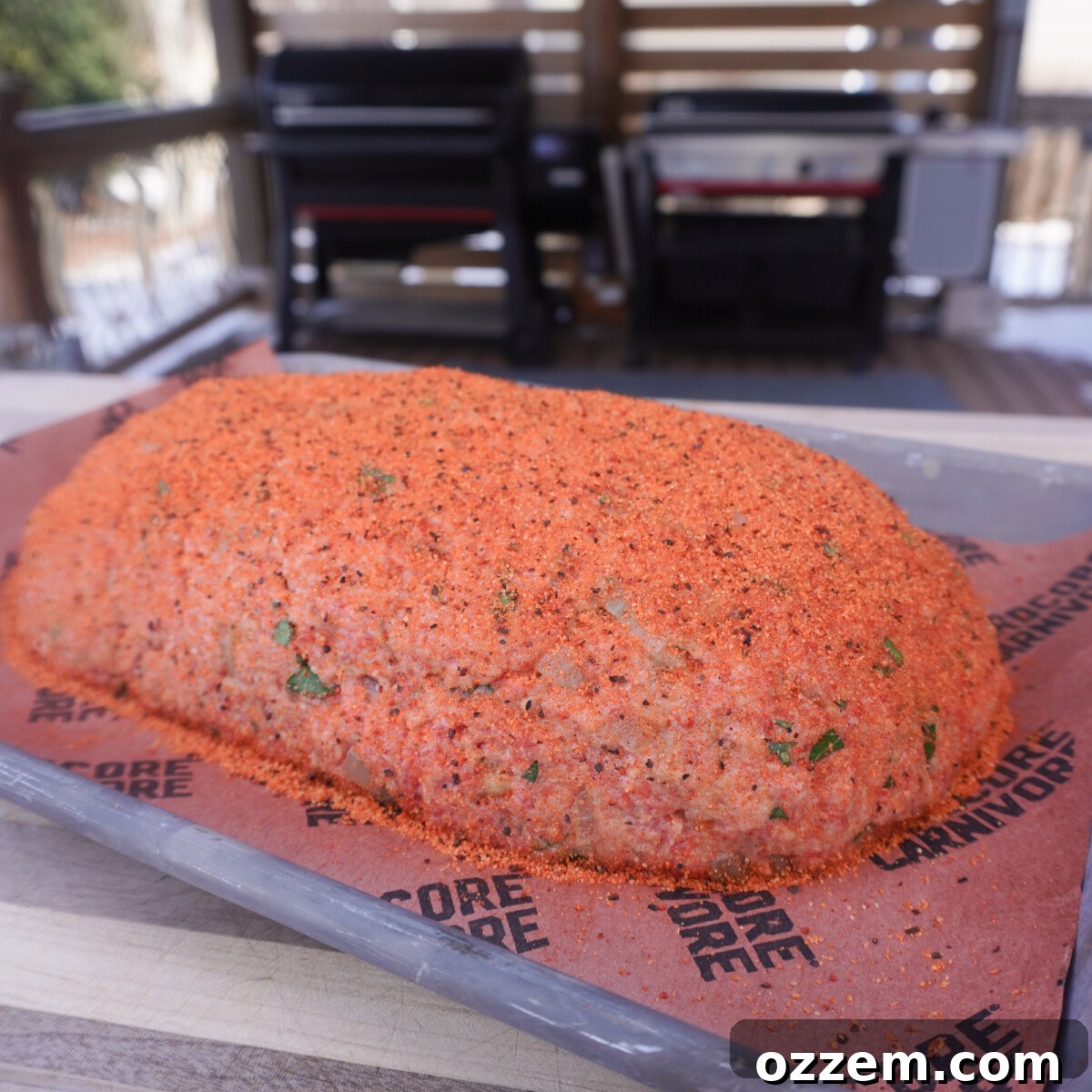 Raw meatloaf mixture seasoned with a generous coating of BBQ rub.