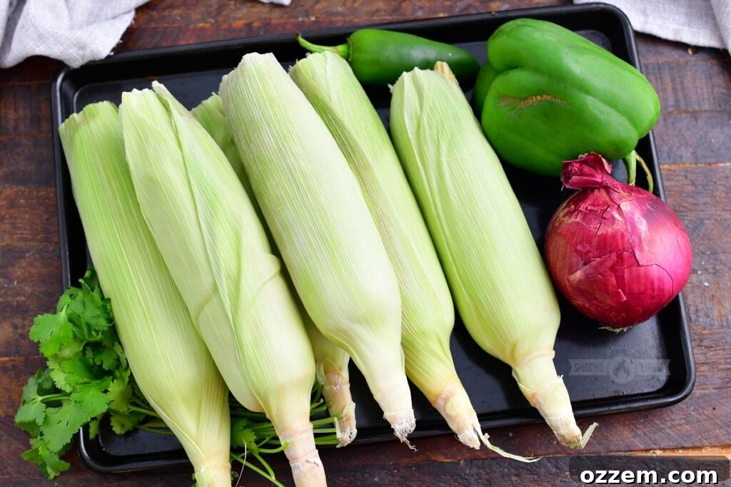 fresh ingredients for grilled corn salad laid out on a metal tray