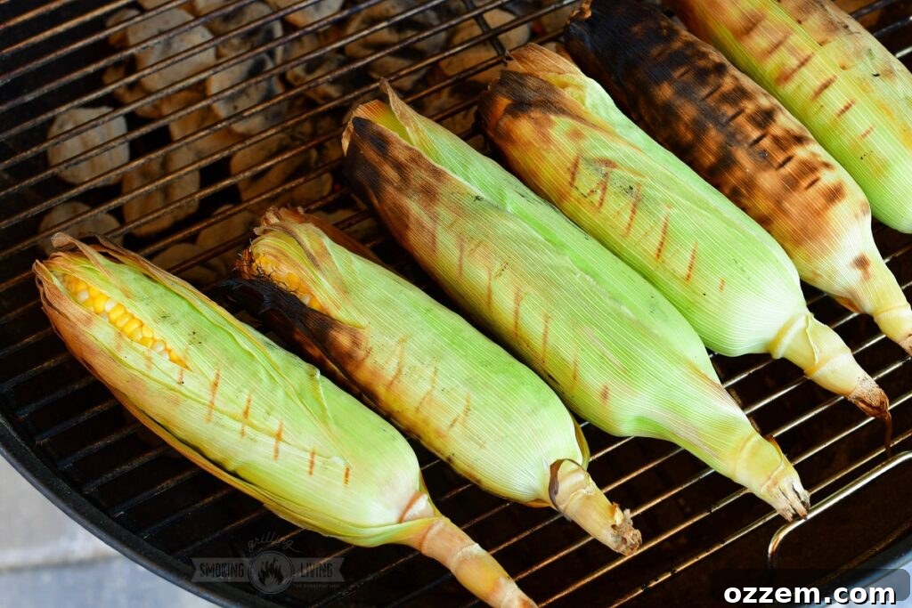 corn in husks grilling on a grill