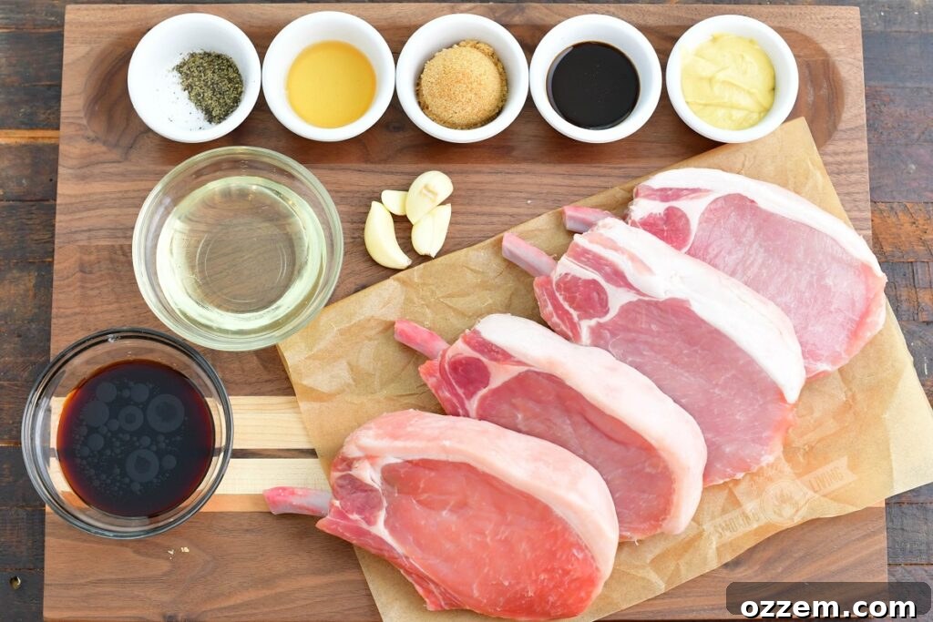 Marinade ingredients laid out on a wooden cutting board: oil, Dijon mustard, Worcestershire sauce, brown sugar, garlic, soy sauce, apple cider vinegar, salt, and pepper.
