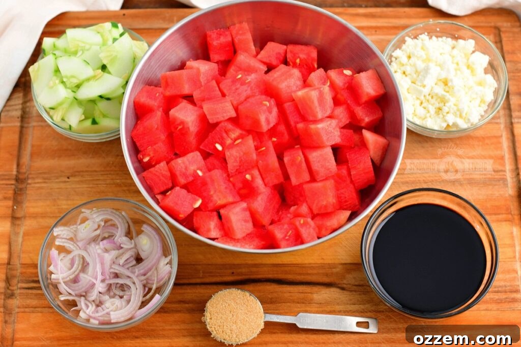 Summer Watermelon Feta Delight 3 Ingredients for Watermelon Feta Salad artfully arranged on a wooden cutting board, ready for preparation.