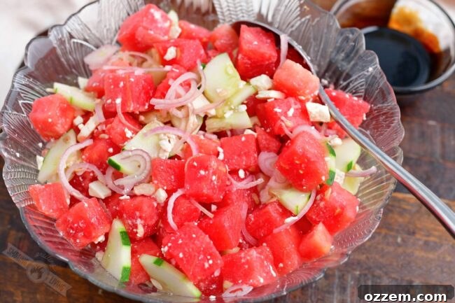 Summer Watermelon Feta Delight 8 Finished Watermelon Feta Salad, undressed, in a glass mixing bowl, ready for serving.