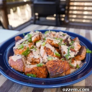 Crispy Cajun Salmon Bites plated with sauce and garnish.