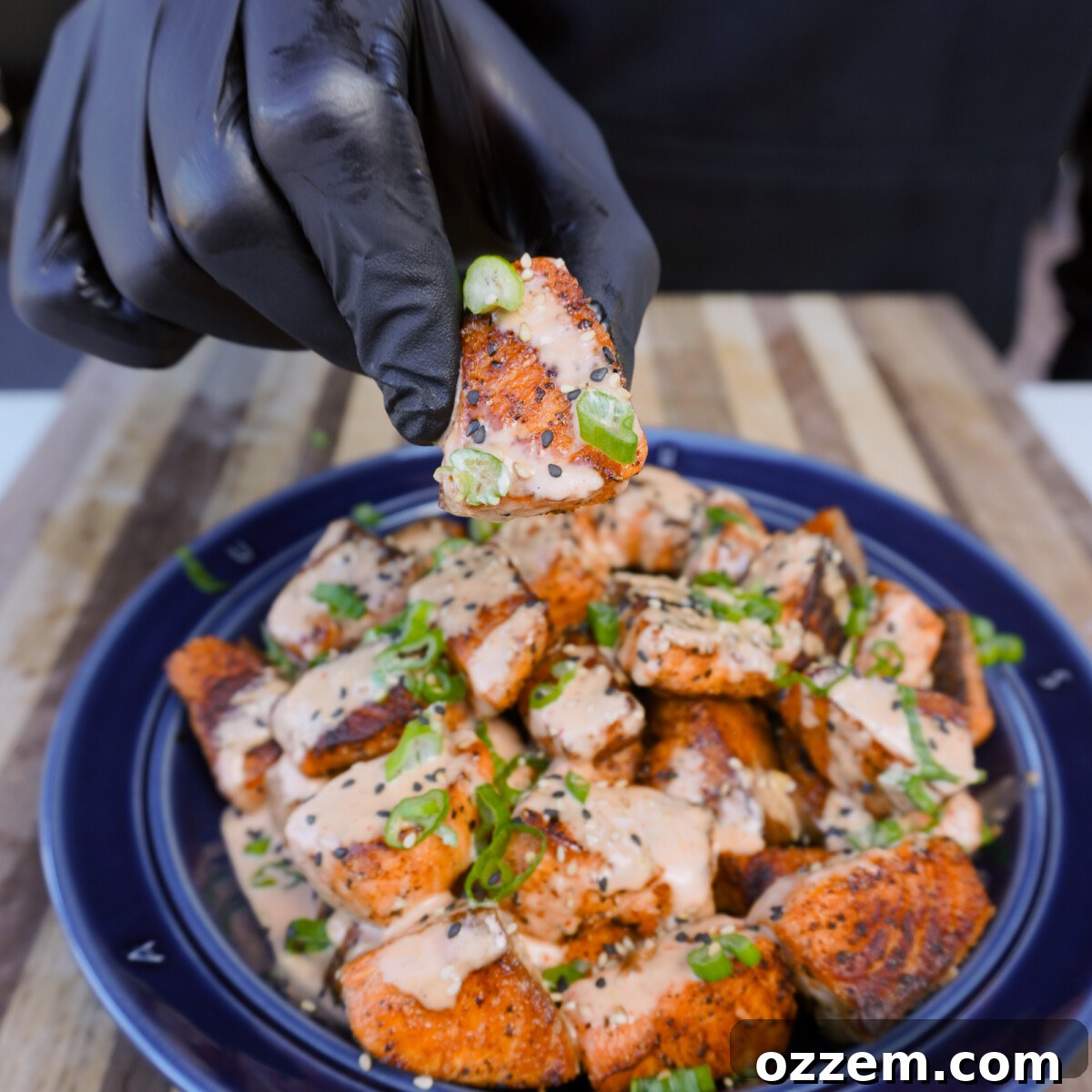 Golden Cajun Salmon Poppers 10 Close-up of crispy cajun salmon bites, garnished and ready to eat.