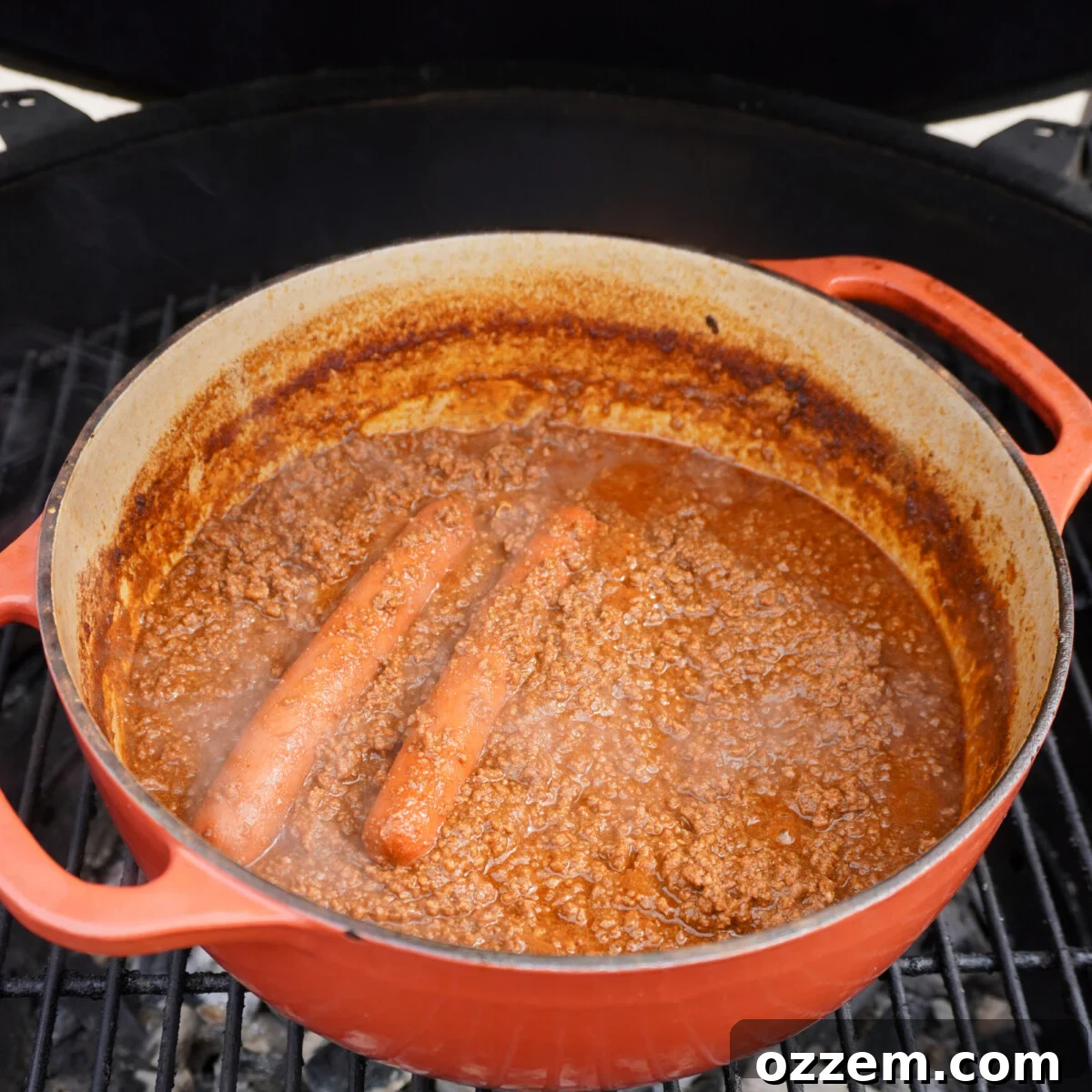 Smoked Chili Fire Dog 7 Hot dogs submerged in flavorful smoked chili in a Dutch oven.