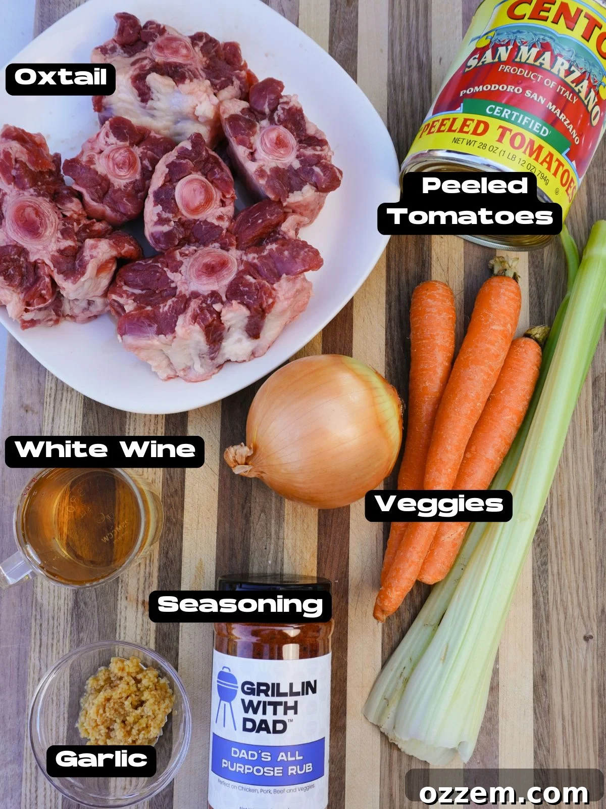 Fresh ingredients for smoked oxtail including carrots, celery, onion, tomatoes, and seasoned oxtail.